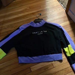 It’s a  purple sweater with purple and black on it I wore jeans and black boots.